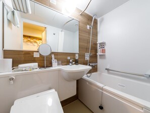 Bathtub, hair dryer, slippers, bidet