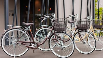 Tre biciclette parcheggiate davanti a un edificio dal design moderno.