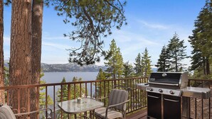 An outdoor deck with a grill, seating area, and a view of a lake and mountains. - Stunning Views at Stargazer | Lakefront Studio! (Crystal Bay)