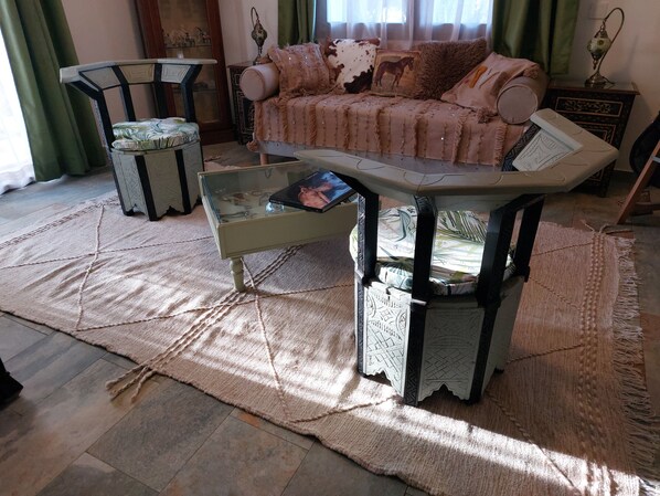 A living room with a sofa, a coffee table, and a chair.