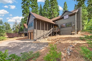 A two-story house with a covered porch and a staircase leading to the upper level. - The Seasons - Tahoe - 4BDR Cabin (Tahoe Vista)