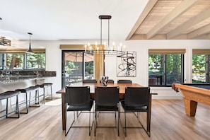 A modern kitchen with a bar area, dining table with chairs, and a pool table. - The Seasons - Tahoe - 4BDR Cabin (Tahoe Vista)