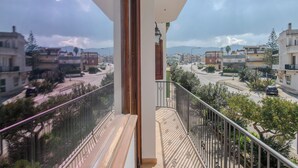 A balcony with a view of a residential street and buildings. - LuminArt (Gibellina)