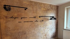 Habitación con pared texturizada, una cita motivacional y diseño moderno y sencillo.