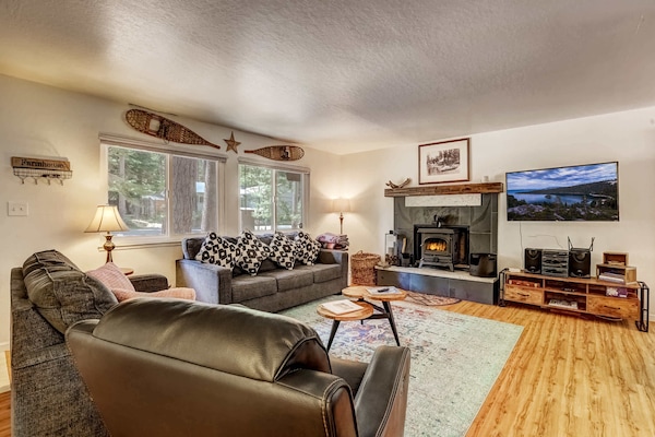 Living room with Roku TV, wood burning fireplace and comfortable seating