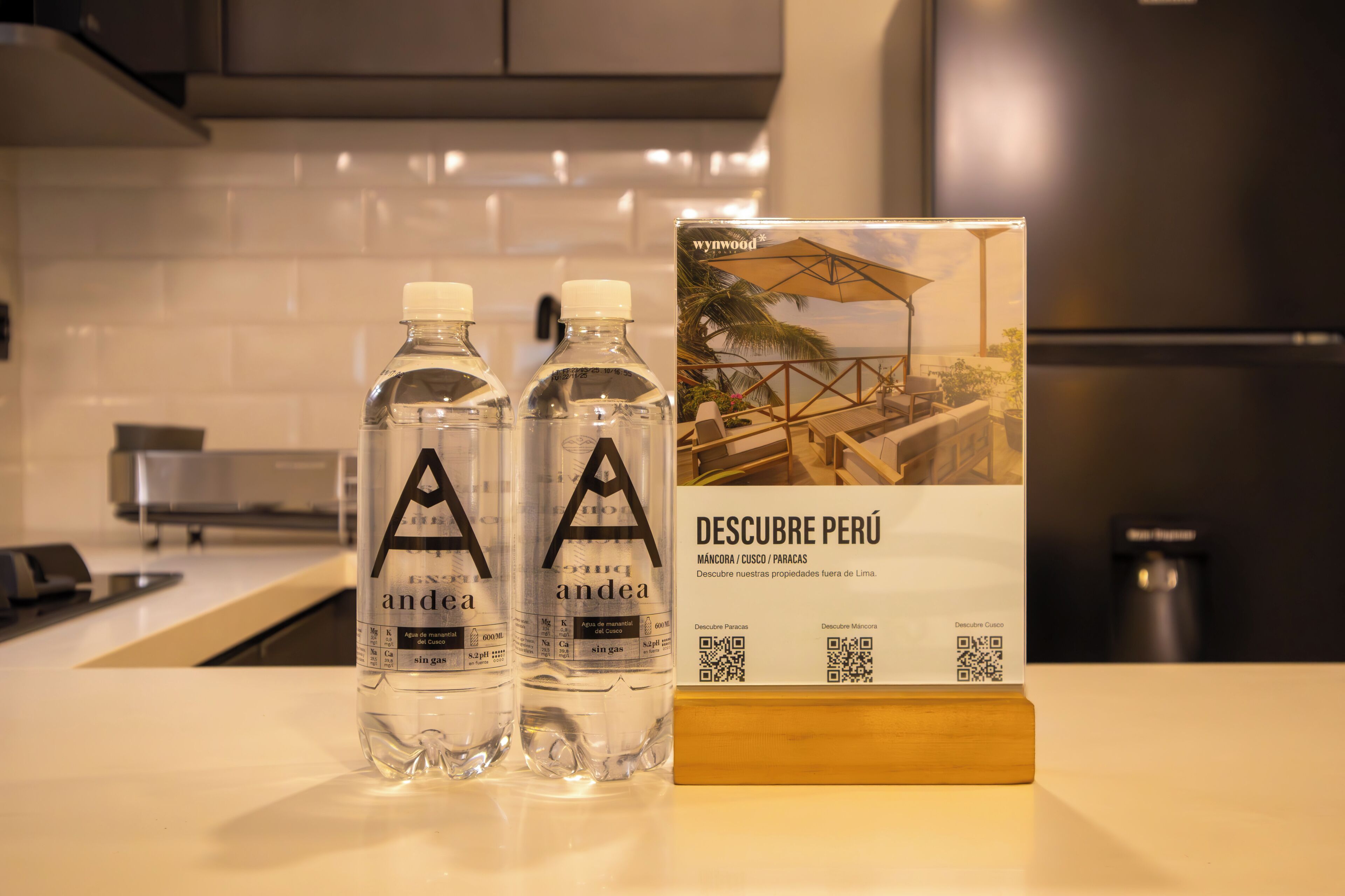 Two bottles of water with labels and a brochure for a property in Peru.