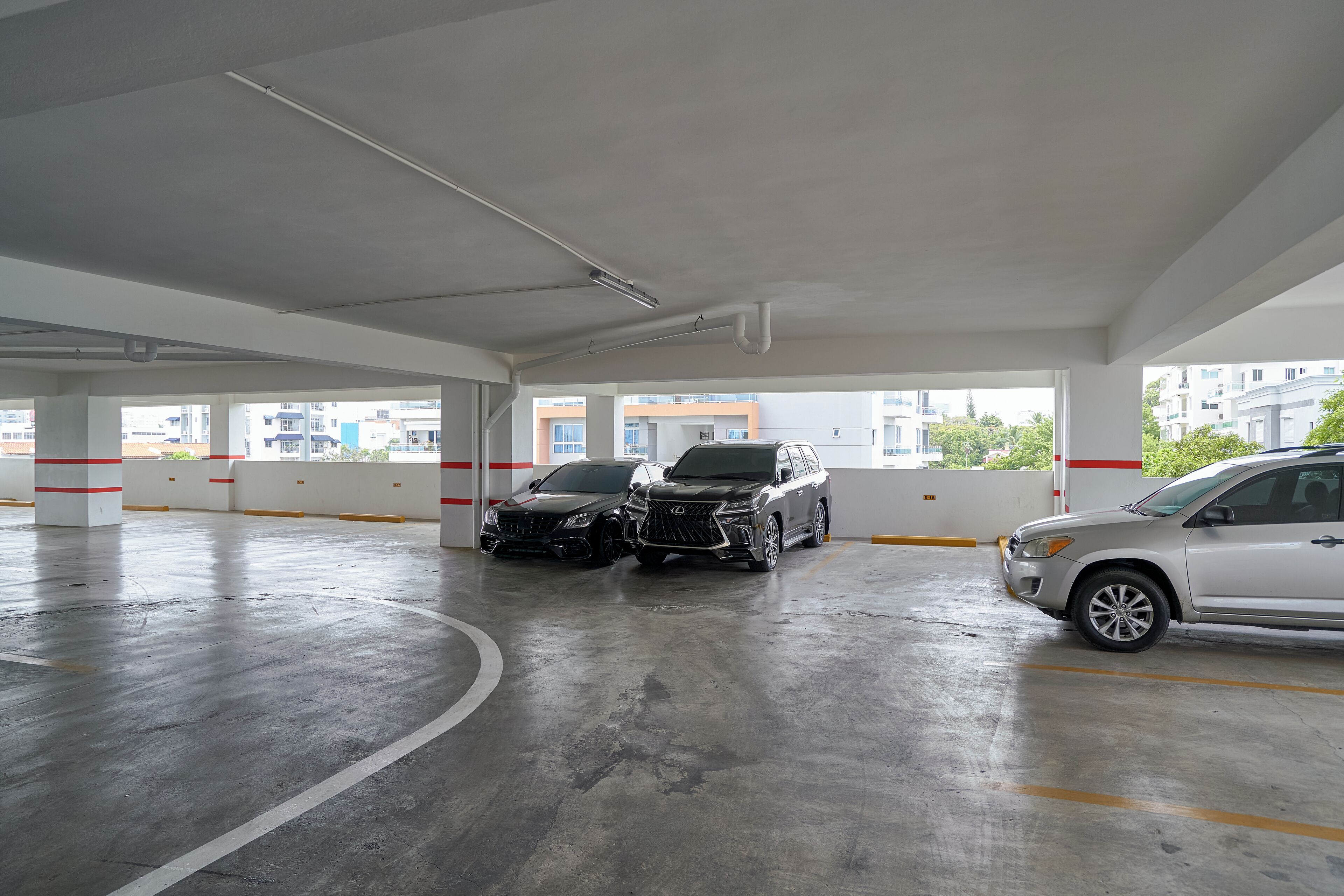 Een parkeergarage met twee SUV's erin.
