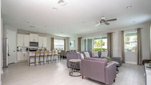 A spacious living area with a kitchen, dining area, and seating.