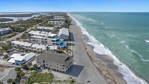 A coastal hotel with multiple buildings, a beach, and ocean views.