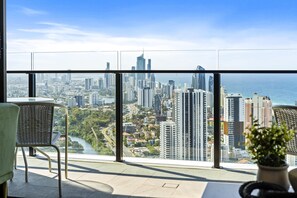 Enjoy a panoramic city view from the comfort of this stylish room, featuring a large window and cozy seating area.