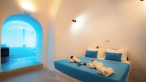 A hotel room with a bed, pillows, and towels.