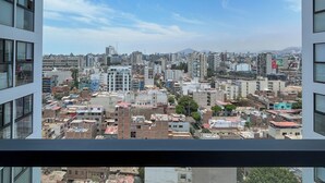A cityscape viewed from a high-rise building with multiple floors and large windows. - Barron by Wynwood House  (Lima)