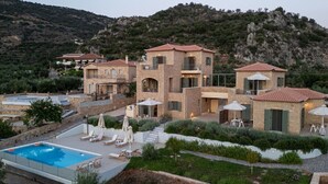 A hillside villa with a swimming pool, outdoor seating, and a view of the surrounding landscape. - Ipso Kardamyli Meropi (Kardamyli)
