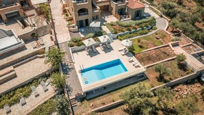 A large, modern villa with a swimming pool, multiple balconies, and a landscaped garden. - Ipsό Kardamyli Nema. (Kardamyli)