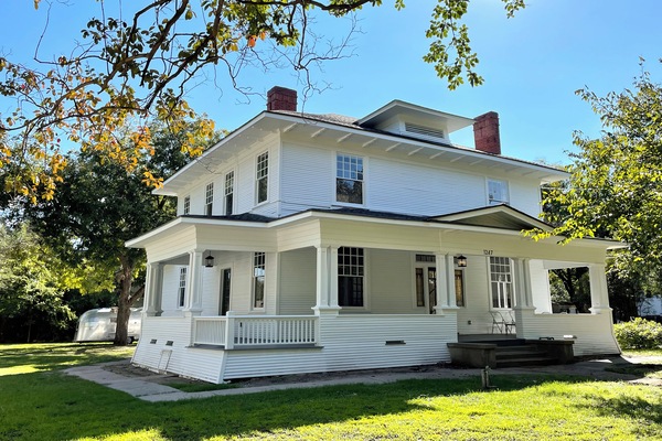 Fully restored 1912 Craftsman home.  Behind, a 1956 Airstream writer's studio.