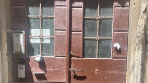 A brown metal door with a keyhole and a lock.