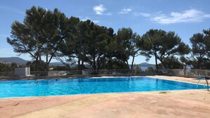 A swimming pool with clear blue water, surrounded by a concrete deck and trees. - Exceptional sea view, air conditioning, parking, private beaches, swimming pools, tennis court, marina. (Bandol)