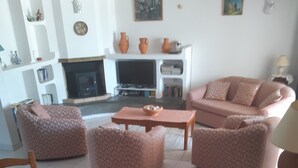 A living room with a sofa set, a coffee table, and a dining table with chairs.