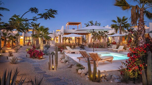 A pool area with lounge chairs and umbrellas, surrounded by cacti and desert plants. - Chic Bungalow with Pool Near the Ocean (El Pescadero)