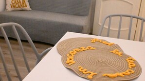 A dining table with a woven placemat and chairs. - A42 - Ancona, two-room apartment in the center (Ancona)