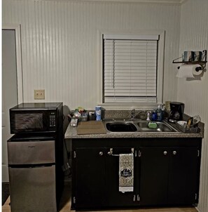 Fridge, microwave, coffee/tea maker, cookware/dishes/utensils
