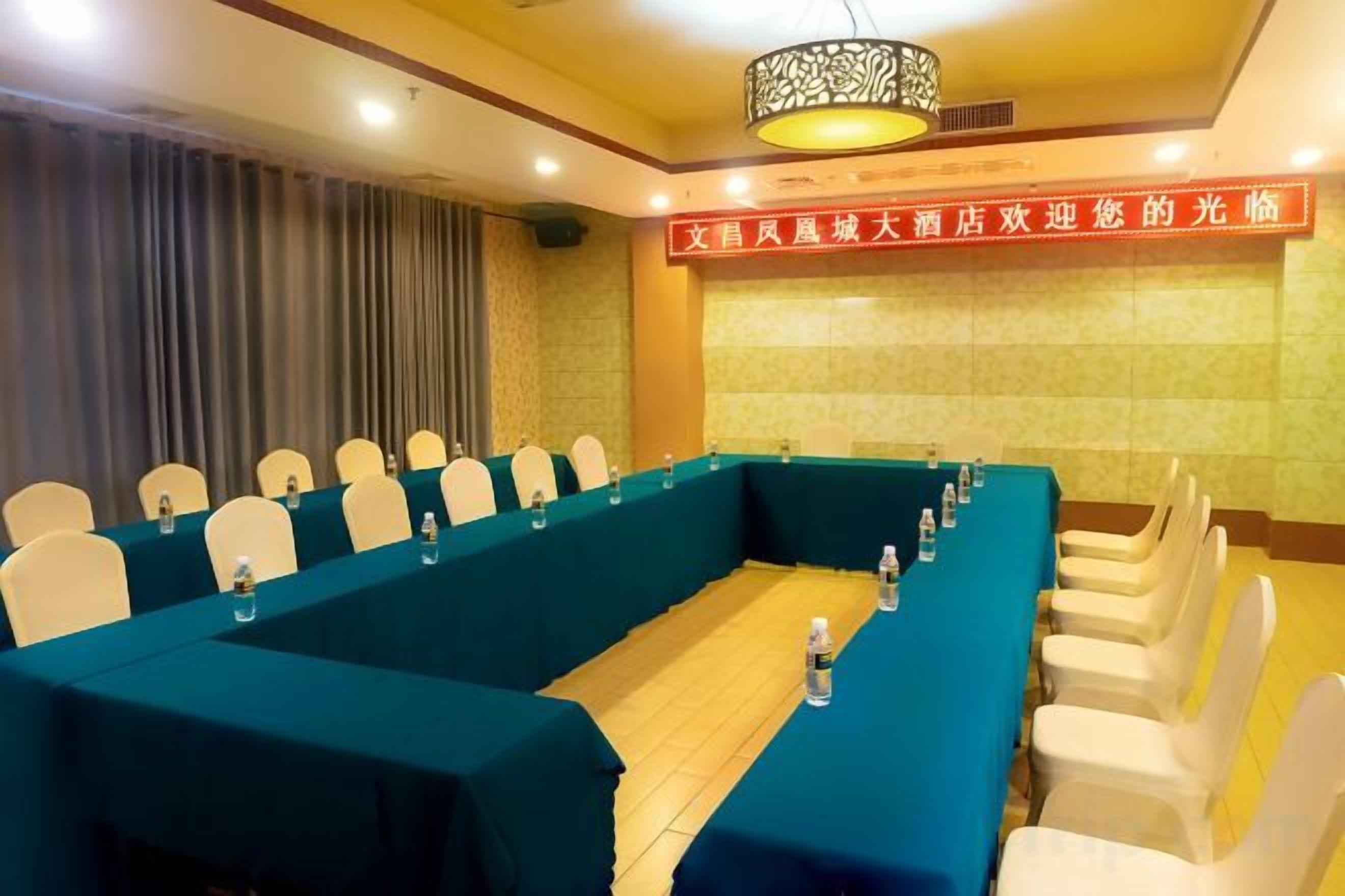 A conference room with a long table, chairs, and a banner.
