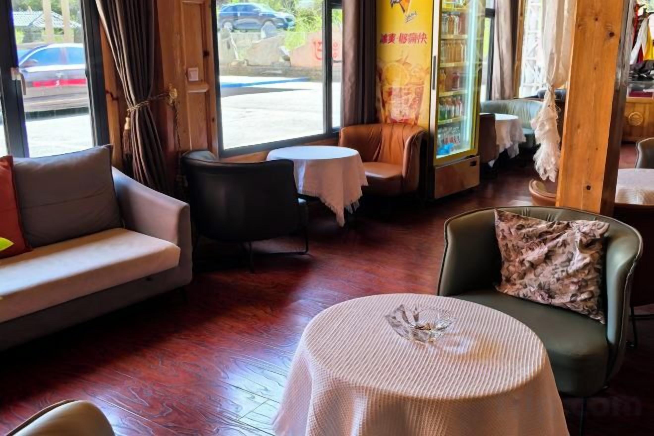 A cozy interior with a sofa, a round table, and a chair, suggesting a comfortable seating area.