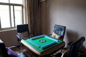 A room with a pool table, two chairs, a window, and a curtain. - Haopai Hotel (Shanghai)