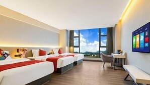 A hotel room with two beds, a desk, a chair, and a large window with a view. - Foshan Yuefeng High-altitude Garden Panorama Hotel (Jiujiangzhen Xinji Plaza) (Foshan)
