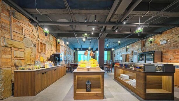 A modern bar area with wooden counters, stone walls, and hanging lights. - Ruishe Hotel (Xintian City Plaza, Licheng) (Quanzhou)
