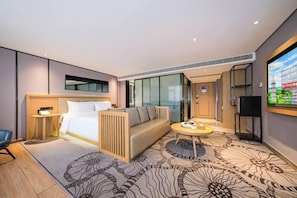 A modern hotel room with a bed, sofa, coffee table, and a television. - Ruishe Hotel (Xintian City Plaza, Licheng) (Quanzhou)