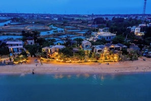 A coastal area with buildings, a beach, and water.