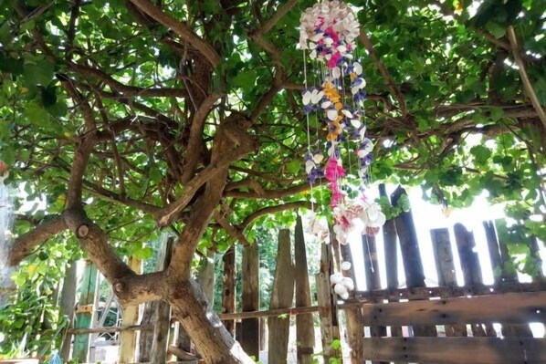 A tree with hanging floral decorations.