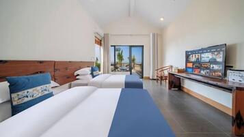 A hotel room with two beds, a TV, and a balcony with a view.