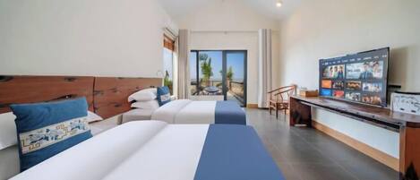 A hotel room with two beds, a TV, and a balcony with a view.