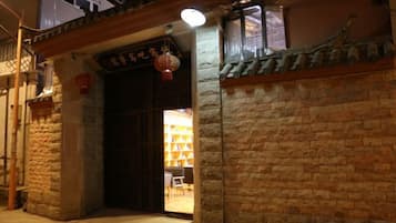A traditional building entrance with a wooden door and a lantern.