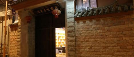 A traditional building entrance with a wooden door and a lantern.