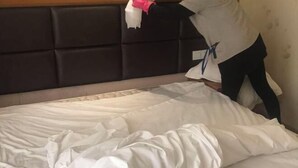 A bed with white bedding and a headboard. - Anna Baige Hotel (Shanghai)