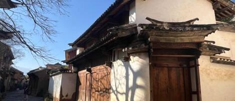 A traditional building with a wooden door and a tiled roof.