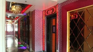 A hotel corridor with patterned walls, a digital sign, and a geometric floor design. - Costa Resort（Xiachuan Island） (Taishan)