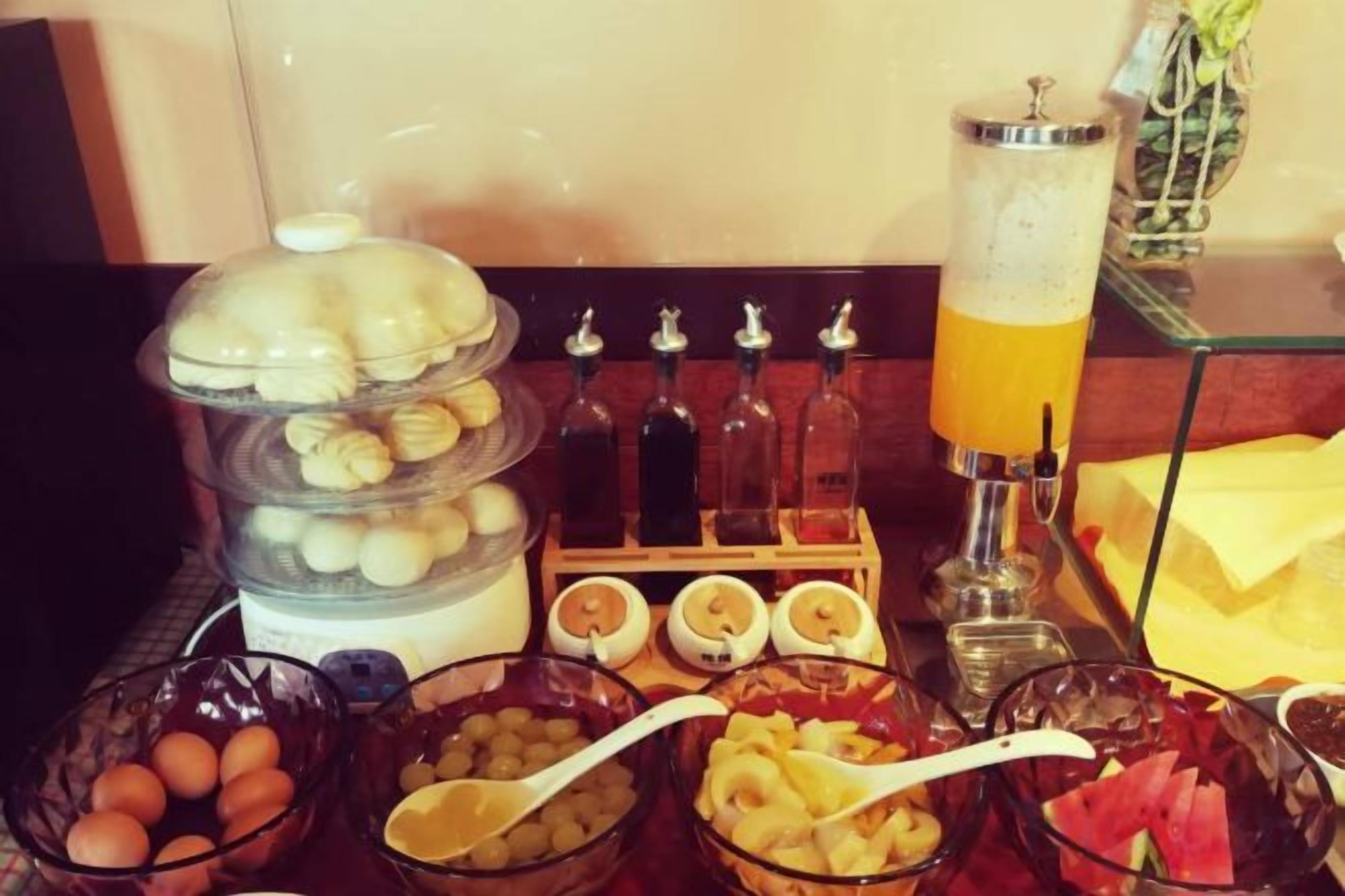 A buffet with various food items and a beverage station.