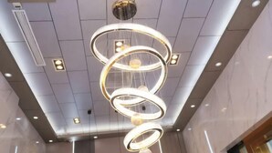 A modern interior with a unique circular chandelier and recessed ceiling lights. - Shanghai Wenfei Boutique Hotel (Shanghai)