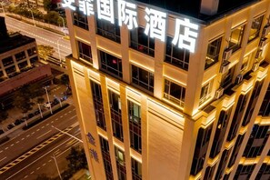 A multi-story hotel building with illuminated signage.