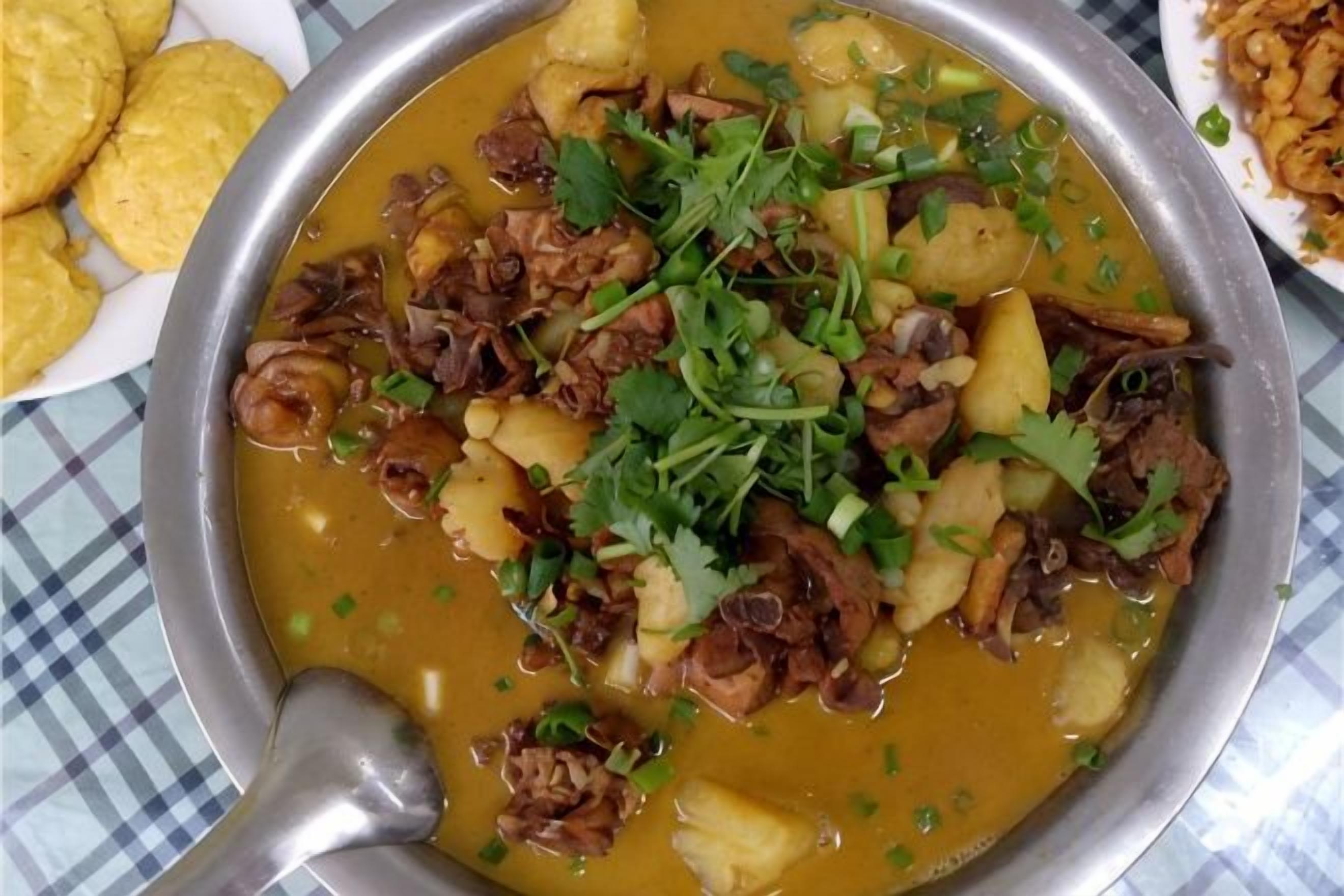 A meal with meat, potatoes, and herbs in a bowl.