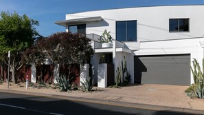 A modern two-story house with a garage, surrounded by desert vegetation. - Stunning Beach Views Pet Friendly Dromana Retreat (Dromana)