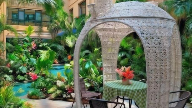 A gazebo with intricate lattice design, surrounded by lush tropical plants and a pool. - Mintai Hot Spring Holiday Hotel (Zibo)
