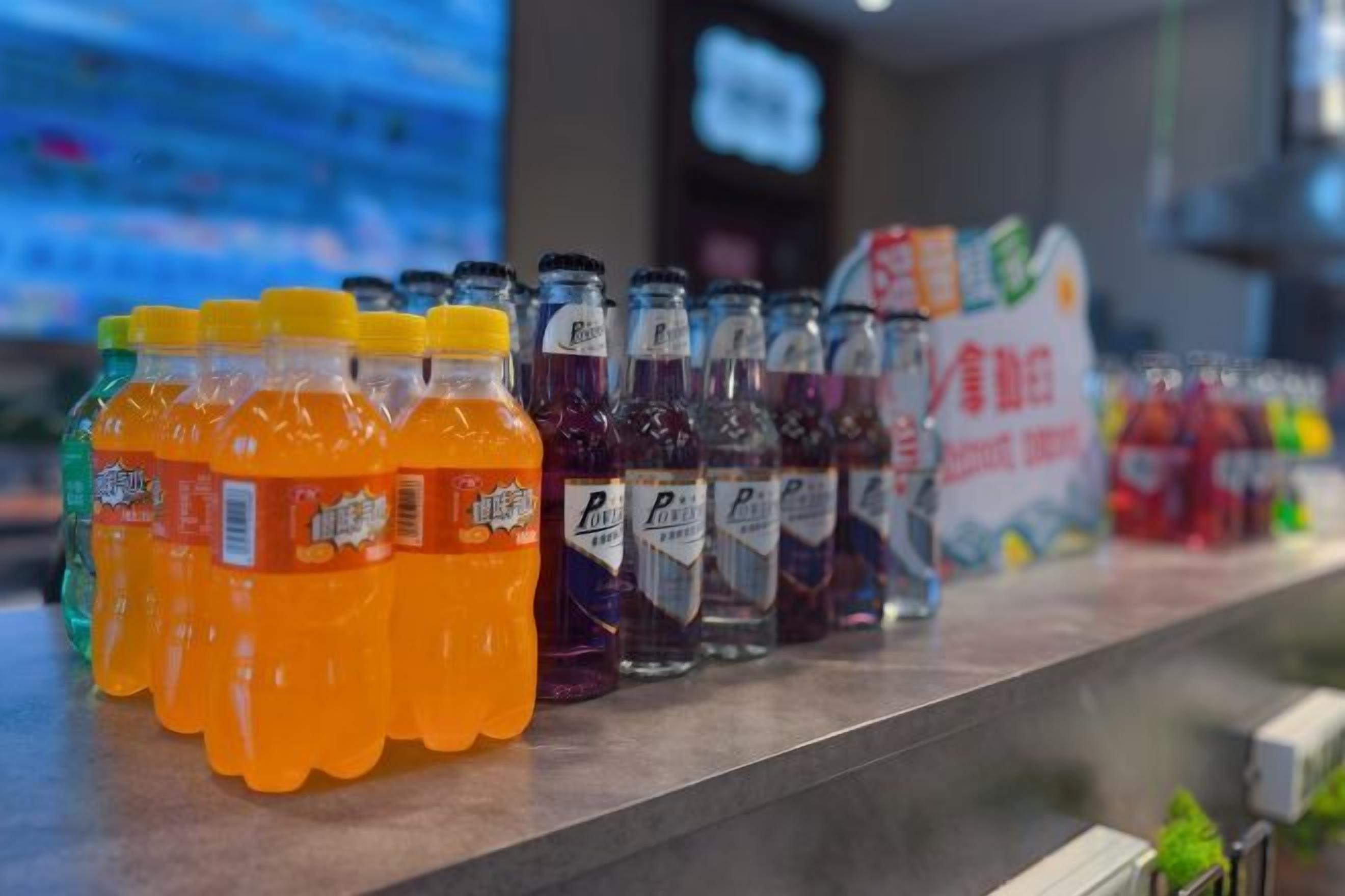A variety of bottled beverages on a shelf.