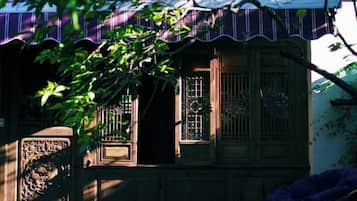 A traditional building with a wooden facade, a tiled roof, and a decorative gate.