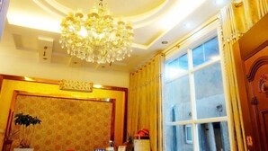 A room with a chandelier, a window with curtains, a patterned wall, and a door with a decorative handle. - Peach blossom island bay longines farmhouse (Zhoushan)