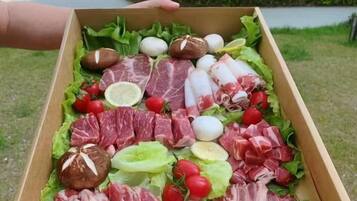 A wooden box filled with various meats, eggs, and vegetables.